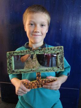 A student holding his finished mirror