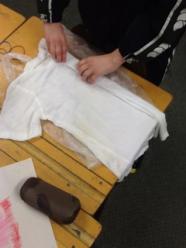 A white T-shirt being pleated before dyeing