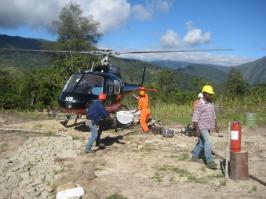 An image of workers and a helicopter in a remote site
