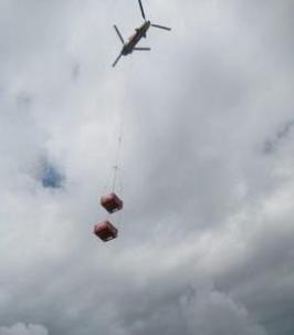 Chinook helicopter lifting two crates