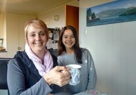 Student and parent holding a cup of tea