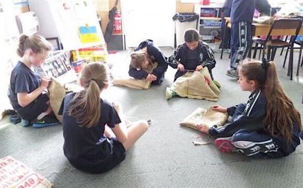 students sewing their library bags