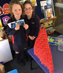 Two students with their tower made using plastic cups