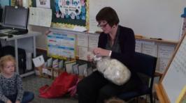 Primary teacher showing wool to the class.