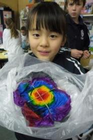 A student holding the T-shirt she has tied and dyed