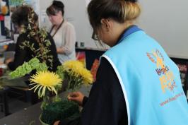 a student making a floral bouquet