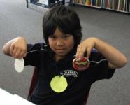 A student with his salt dough medals.