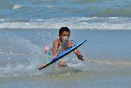 Child body boarding at the beach
