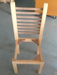 An unfinished wooden chair