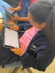 Child creating image on a digital tablet.