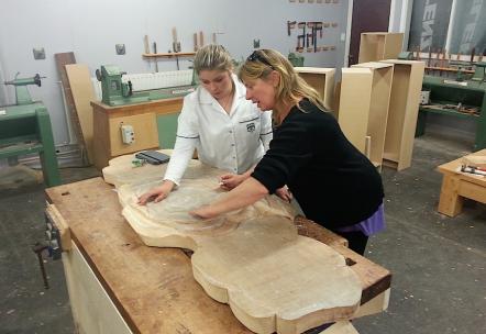 Emma Thorburn marking her design on her wooden headboard with a teacher