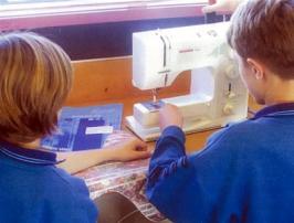 Kids using sewing machine.
