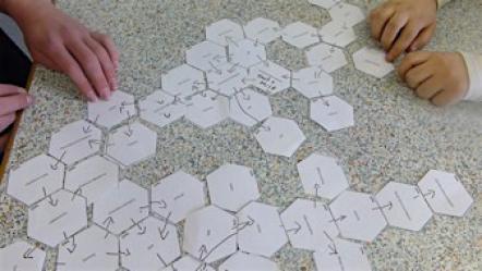 Students placing hexagons with key words