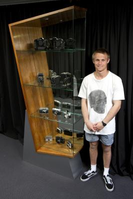 Logan with the photography cabinet he built