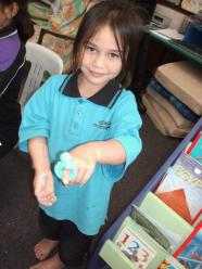 Modelling a ring with play dough.