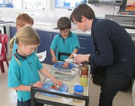 Students adding fillings to biscuits
