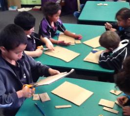 Students making cardboard models of the shade house