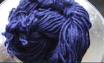 Purple dyed wool in a glass bowl