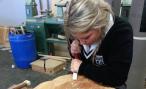 Student carving wooden headboard