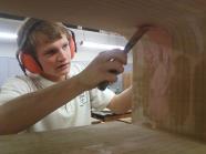 Student working on the wooden frame