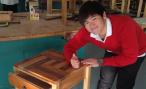 A student displays his coffee table and gives a thumbs up
