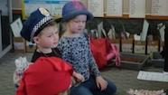 Year 1–2 students trying on hats